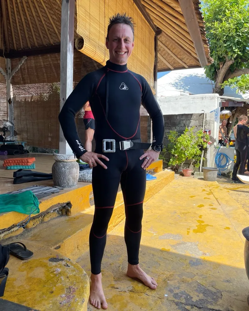 Alex in a freediving wetsuit and weight belt
